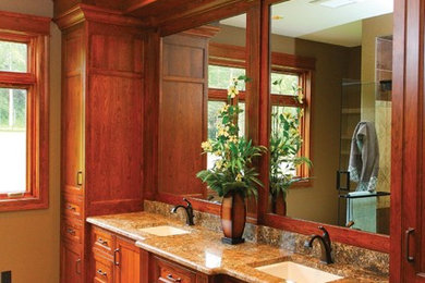 Elegant master porcelain tile bathroom photo in Other with medium tone wood cabinets and granite countertops