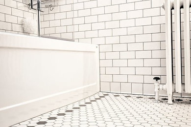 Mid-sized elegant 3/4 white tile and subway tile porcelain tile and white floor bathroom photo in Other with a two-piece toilet, gray walls, a console sink, a hinged shower door and gray countertops