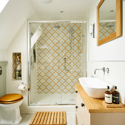 Inspiration for a small timeless master multicolored tile and ceramic tile ceramic tile and beige floor bathroom remodel in Sussex with flat-panel cabinets, beige cabinets, a one-piece toilet, white walls, a trough sink, wood countertops and beige countertops