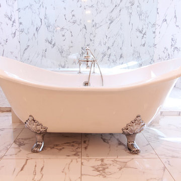 Claw Foot Tub with Polished Chrome Feet Sits in front of Shower