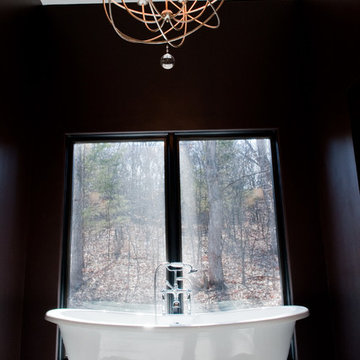 Claw Tub flanked by black walls and large window