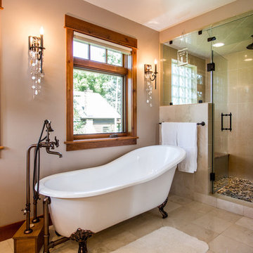 Clawfoot soaking tub with freestanding faucet and steam shower in master bathroo