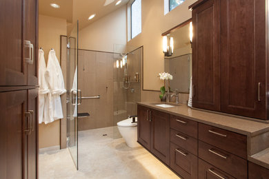 Inspiration for a large transitional master porcelain tile and beige tile porcelain tile and beige floor walk-in shower remodel in Portland with a one-piece toilet, an undermount sink, quartz countertops, a hinged shower door, recessed-panel cabinets, dark wood cabinets and beige walls