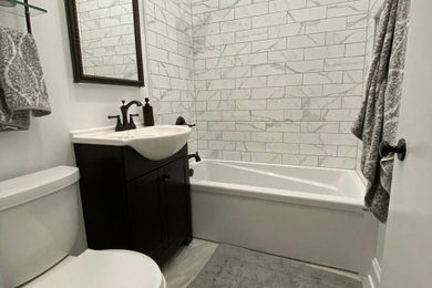 Bathroom - small eclectic master white tile marble floor bathroom idea in Chicago with flat-panel cabinets, dark wood cabinets and a console sink