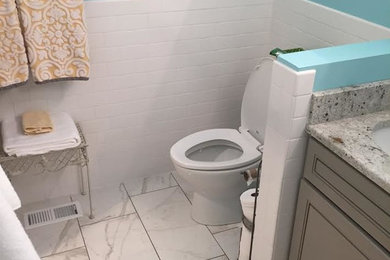 Inspiration for a mid-sized transitional 3/4 white tile and subway tile porcelain tile and white floor bathroom remodel in Salt Lake City with recessed-panel cabinets, beige cabinets, a two-piece toilet, blue walls, an undermount sink and granite countertops