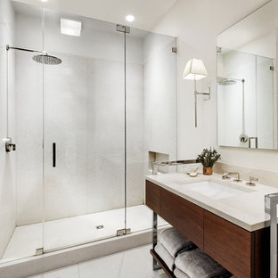 Eclectic white tile alcove shower photo in New York with an undermount sink, flat-panel cabinets and dark wood cabinets