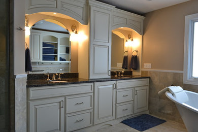 Example of a large classic master beige tile and porcelain tile porcelain tile bathroom design in Other with an undermount sink, furniture-like cabinets, white cabinets, granite countertops and beige walls