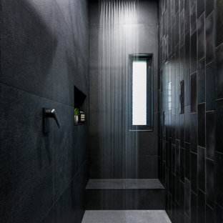 Photo of a contemporary bathroom in Sydney with black tile and grey floor.