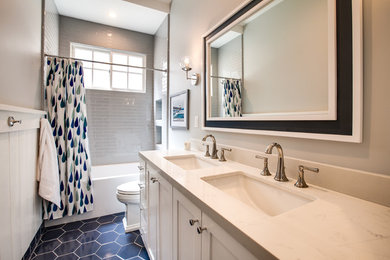 Example of a beach style 3/4 gray tile and ceramic tile ceramic tile and blue floor bathroom design in San Diego with shaker cabinets, white cabinets, a one-piece toilet, gray walls, an undermount sink, quartz countertops and white countertops