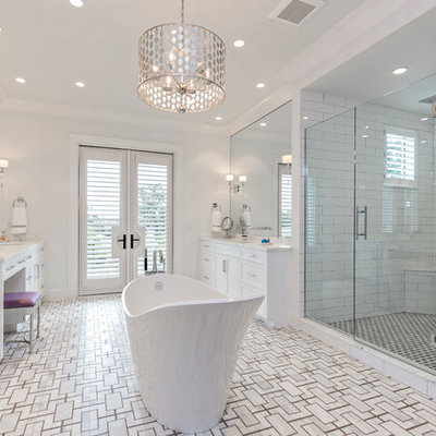 Large transitional master white tile and ceramic tile mosaic tile floor freestanding bathtub photo in Miami with white cabinets, white walls, an undermount sink, marble countertops, a hinged shower door and white countertops