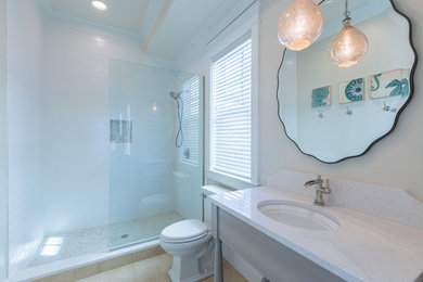 Inspiration for a mid-sized transitional 3/4 subway tile ceramic tile alcove shower remodel in Jacksonville with flat-panel cabinets, gray cabinets, a two-piece toilet, white walls and a wall-mount sink
