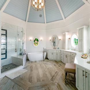 Inspiration for a coastal master medium tone wood floor, brown floor, double-sink, exposed beam, shiplap ceiling and vaulted ceiling bathroom remodel in Baltimore with recessed-panel cabinets, gray cabinets, white walls, an undermount sink, a hinged shower door, white countertops and a built-in vanity