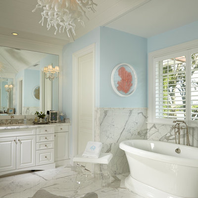Inspiration for a coastal white tile white floor freestanding bathtub remodel in Miami with raised-panel cabinets, white cabinets, blue walls and white countertops