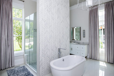 Inspiration for a large contemporary master white tile and marble tile white floor bathroom remodel in Nashville with furniture-like cabinets, white cabinets, gray walls, a vessel sink, quartz countertops, gray countertops and a hinged shower door
