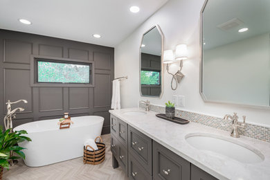 Example of a transitional master double-sink and wainscoting freestanding bathtub design in Milwaukee with gray cabinets, white walls, an undermount sink and quartz countertops