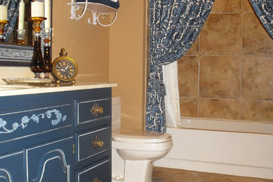 Diseño de cuarto de baño clásico grande con puertas de armario azules, combinación de ducha y bañera, sanitario de una pieza, baldosas y/o azulejos beige, baldosas y/o azulejos de cerámica, paredes beige, suelo de baldosas de cerámica y aseo y ducha
