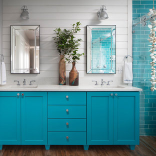 Design ideas for a beach style master wet room bathroom in Seattle with shaker cabinets, turquoise cabinets, a freestanding tub, blue tile, subway tile, white walls, dark hardwood floors, an undermount sink, brown floor, white benchtops and a sliding shower screen.