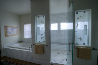 Example of a large country master white tile and subway tile medium tone wood floor bathroom design in Denver with beige walls and a hinged shower door