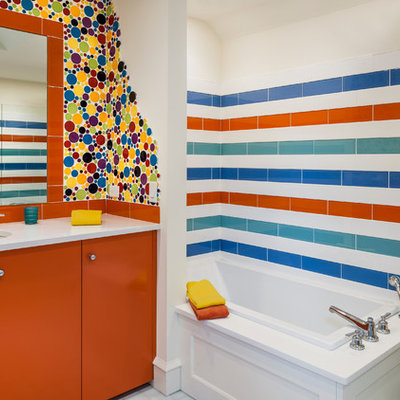 Drop-in bathtub - eclectic kids' multicolored tile, blue tile, orange tile, white tile and ceramic tile drop-in bathtub idea in Philadelphia with flat-panel cabinets, orange cabinets, a one-piece toilet and an undermount sink