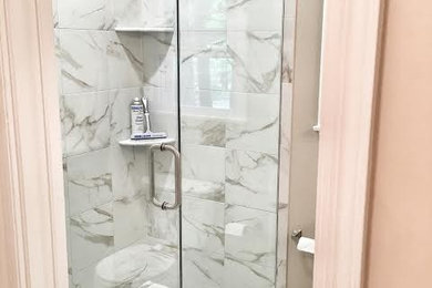 Inspiration for a mid-sized contemporary marble floor alcove shower remodel in New York with gray walls