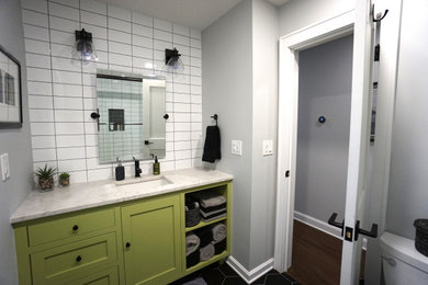 Small contemporary bathroom in Columbus with shaker cabinets, green cabinets, a one-piece toilet, white tiles, porcelain tiles, grey walls, ceramic flooring, a submerged sink, marble worktops, black floors, white worktops, a single sink and a built in vanity unit.