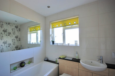 Small contemporary family bathroom in Other with flat-panel cabinets, light wood cabinets, granite worktops and porcelain tiles.