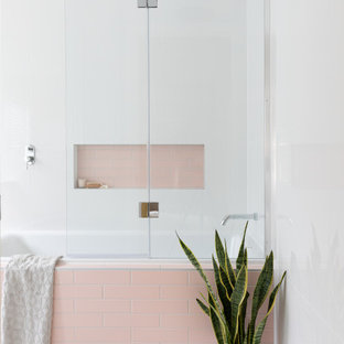 Inspiration for a small contemporary kids bathroom in Brisbane with a drop-in tub, a shower/bathtub combo, pink tile, white walls, grey floor and a built-in vanity.