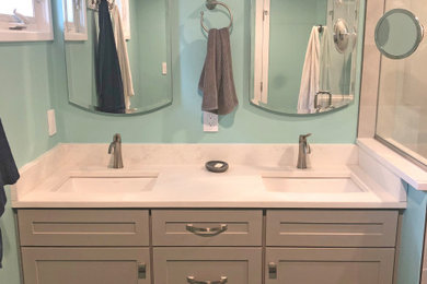 Example of a small transitional master gray tile and porcelain tile porcelain tile, gray floor and double-sink bathroom design in Baltimore with shaker cabinets, gray cabinets, a two-piece toilet, blue walls, an undermount sink, quartz countertops, a hinged shower door, white countertops and a built-in vanity
