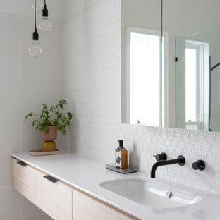 This is an example of a large contemporary master bathroom in Melbourne with flat-panel cabinets, white tile, mosaic tile, white walls, ceramic floors, grey floor, a floating vanity, light wood cabinets, an undermount sink and white benchtops.