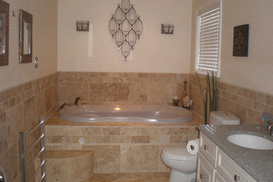 Bathroom - mid-sized transitional master beige tile and stone tile travertine floor bathroom idea in Other with an undermount sink, raised-panel cabinets, beige cabinets, granite countertops, a two-piece toilet and yellow walls