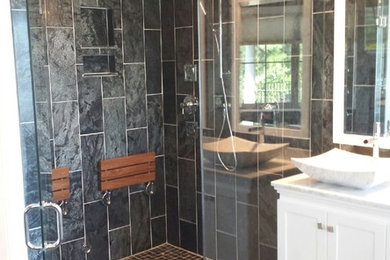 Bathroom - large contemporary master black tile and stone tile slate floor bathroom idea in Other with a vessel sink, shaker cabinets, white cabinets, marble countertops, a two-piece toilet and white walls