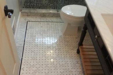 Example of a mid-sized classic 3/4 marble floor and multicolored floor bathroom design in Chicago with furniture-like cabinets, black cabinets, a two-piece toilet, gray walls, an undermount sink, marble countertops and white countertops