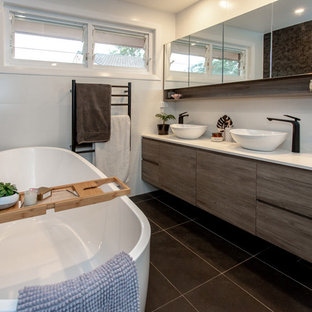 Mid-sized contemporary bathroom in Sydney with flat-panel cabinets, medium wood cabinets, a freestanding tub, white tile, ceramic tile, white walls, porcelain floors, a vessel sink, engineered quartz benchtops, grey floor and white benchtops.