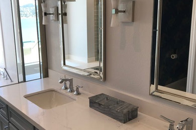 Inspiration for a large timeless master gray floor bathroom remodel in San Francisco with recessed-panel cabinets, gray cabinets, gray walls, an undermount sink, marble countertops and white countertops