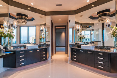 Large trendy master beige floor bathroom photo in Tampa with flat-panel cabinets, black cabinets, beige walls, a vessel sink, granite countertops and a hinged shower door