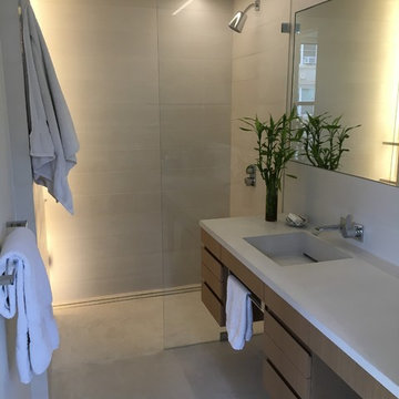 Concrete bathroom finishes - tiles, floor, sink.Private residence - Manhattan.