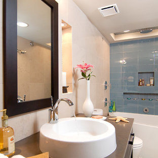 Inspiration for a transitional blue tile and glass tile bathroom remodel in Other with a console sink