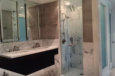 Example of a transitional master white tile and stone tile marble floor bathroom design in Chicago with furniture-like cabinets, dark wood cabinets, marble countertops, an undermount tub, an undermount sink and gray walls