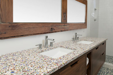 This is an example of a large contemporary ensuite bathroom in Charleston with flat-panel cabinets, dark wood cabinets, an alcove shower, a one-piece toilet, white tiles, metro tiles, white walls, a submerged sink, recycled glass worktops, multi-coloured floors, an open shower and mosaic tile flooring.