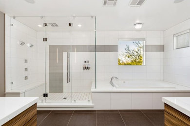 Huge trendy master white tile and ceramic tile porcelain tile and brown floor bathroom photo in Other with flat-panel cabinets, medium tone wood cabinets, a one-piece toilet, white walls, an integrated sink, quartz countertops and a hinged shower door