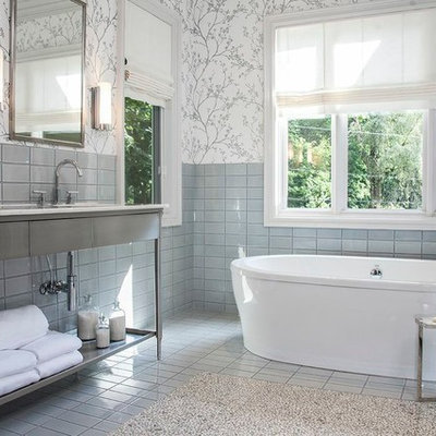 Trendy freestanding bathtub photo in Detroit with a console sink