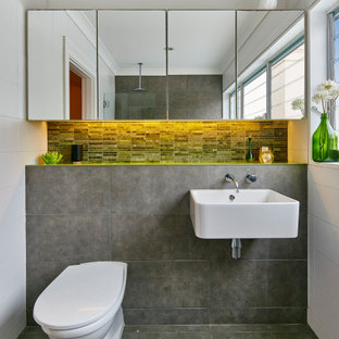 Design ideas for a contemporary bathroom in Sydney with a one-piece toilet, gray tile, a wall-mount sink, grey floor and a single vanity.