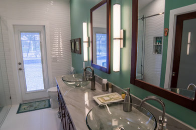 Example of a mid-sized trendy 3/4 white tile and porcelain tile porcelain tile alcove shower design in Miami with flat-panel cabinets, dark wood cabinets, a one-piece toilet, green walls, a vessel sink and quartzite countertops