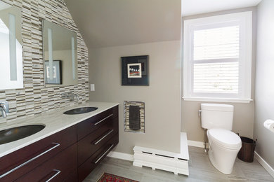 Inspiration for a mid-sized contemporary master gray tile and mosaic tile porcelain tile alcove shower remodel in Other with flat-panel cabinets, dark wood cabinets, a two-piece toilet, gray walls, an undermount sink and quartz countertops