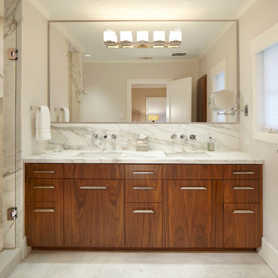 Trendy white tile and marble tile alcove shower photo in Dallas with an undermount sink, flat-panel cabinets, medium tone wood cabinets and marble countertops