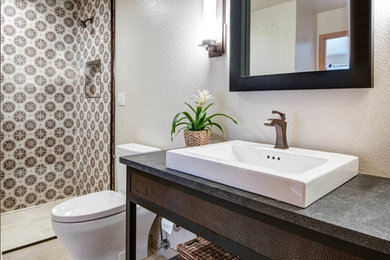 Example of a mid-sized trendy 3/4 porcelain tile and beige floor bathroom design in Denver with a two-piece toilet, beige walls, a vessel sink, concrete countertops and gray countertops