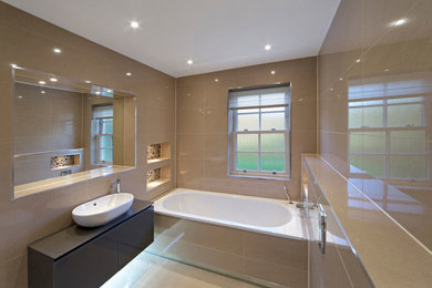 Inspiration for a large contemporary master drop-in bathtub remodel in Vancouver with flat-panel cabinets, dark wood cabinets and beige walls