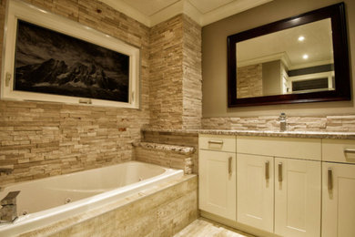 Idée de décoration pour une salle de bain principale design de taille moyenne avec un placard à porte shaker, des portes de placard blanches, une baignoire posée, un carrelage beige, des carreaux de céramique, un mur gris, un sol en carrelage de céramique, un lavabo encastré et un plan de toilette en granite.