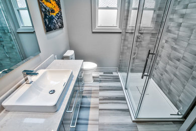 Bathroom - mid-sized contemporary 3/4 gray tile and subway tile porcelain tile and gray floor bathroom idea in Toronto with flat-panel cabinets, gray cabinets, a one-piece toilet, gray walls, a vessel sink, quartz countertops and gray countertops