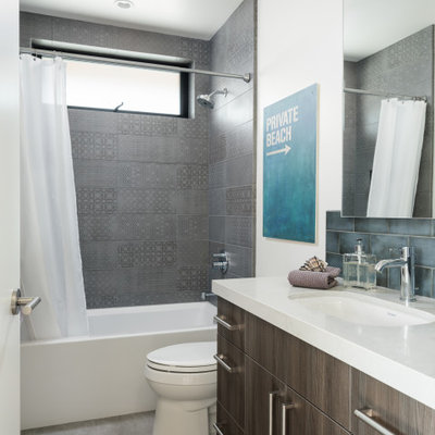 Bathroom - contemporary gray tile gray floor and single-sink bathroom idea in San Diego with flat-panel cabinets, gray cabinets, white walls, an undermount sink and white countertops